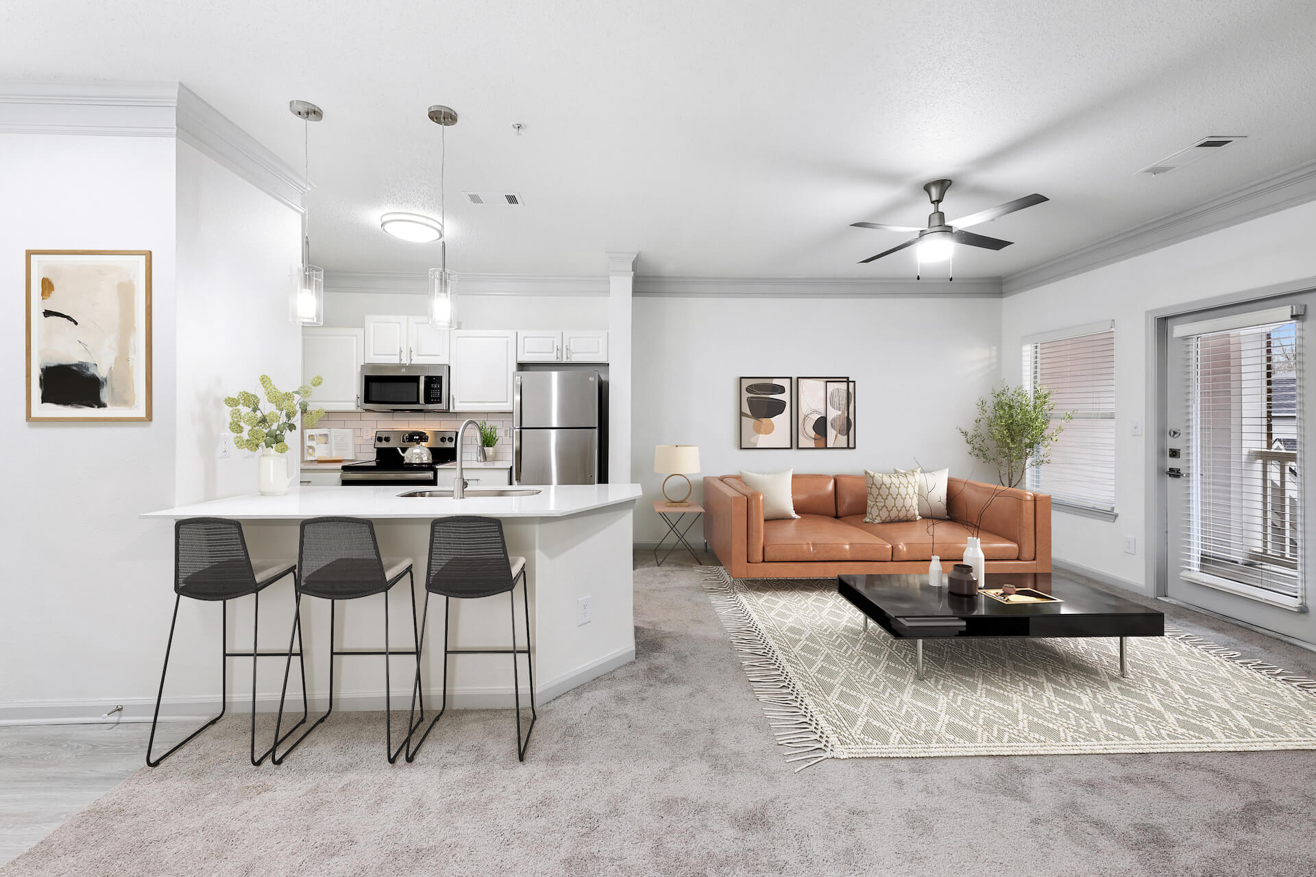 CArpeted living room and open kitchen